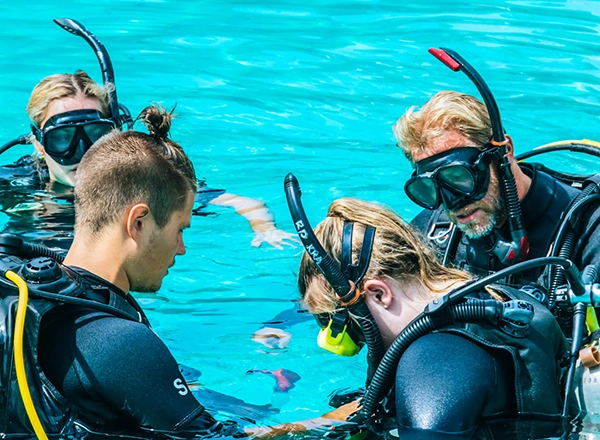 PADI Open Water students practicing skills underwater in Camiguin